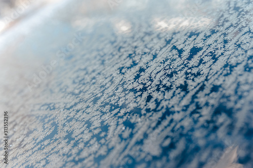 abstract texture of snowflakes and ice on blue and white glass