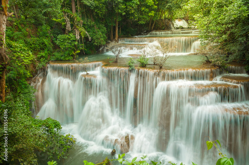 Breathtaking waterfall at deep forest, Tropical rain forest or evergreen forest with waterfall, Erawan waterfall located Kanchanaburi Province, Thailand © peangdao