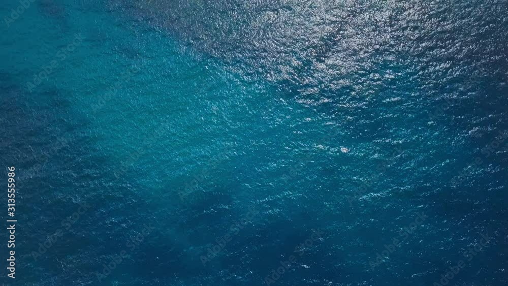 Cinemagraph of the sea surface with rolling waves and ripples. Aerial top to down view. Natural loopable seamless background