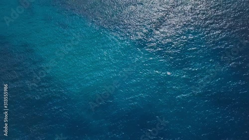 Cinemagraph of the sea surface with rolling waves and ripples. Aerial top to down view. Natural loopable seamless background
