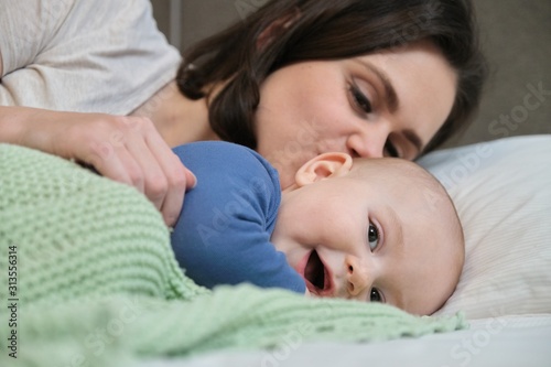 Portrait of beautiful young mother and her baby 7 month old son