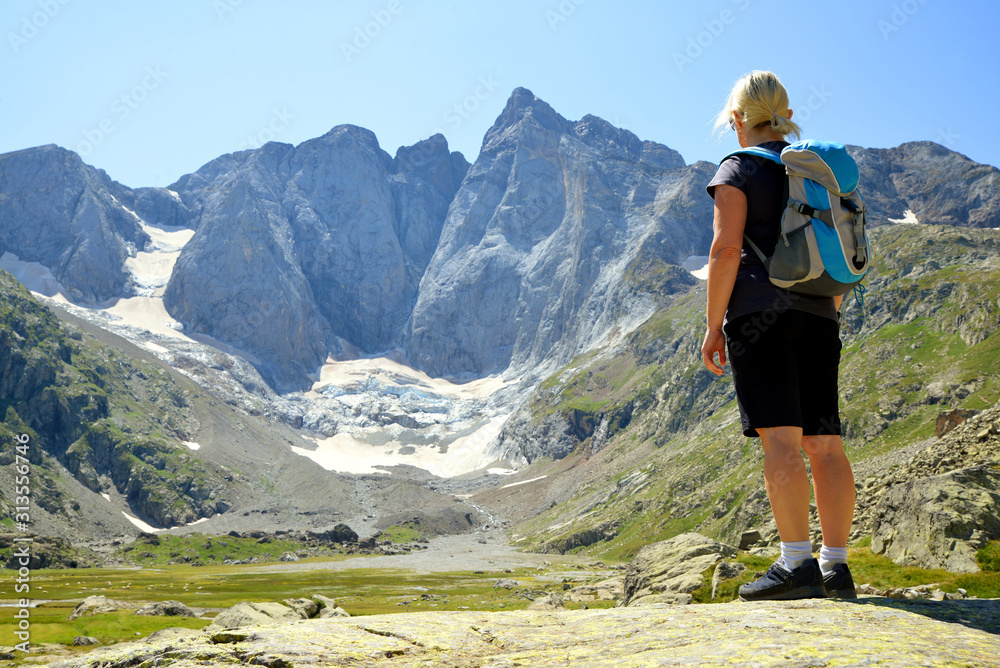Tourist in the mountain landscape. Vignemale massif. French Pyrenees.