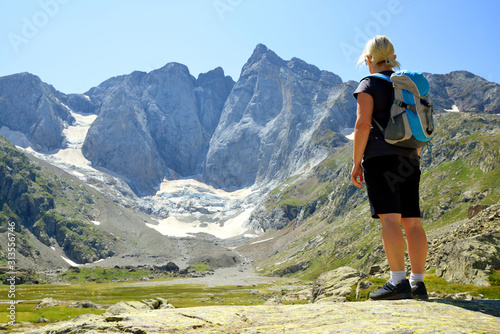 Tourist in the mountain landscape. Vignemale massif. French Pyrenees.