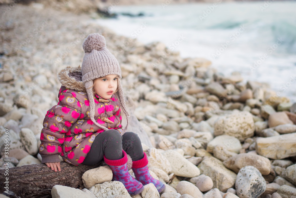 Portrait of cute little girl playing on the beach Portrait of cute little girl playing on the beach