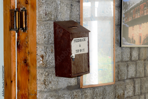 Wooden Suggestion or Complaint Box or Letter Box mounting on doorway Wall of a tourist resort hotel reception Home Office to lock and secure suggestions ballots mails of customer service feedback. photo
