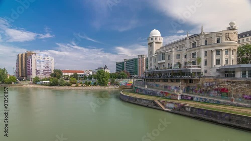 Urania and Danube Canal timelapse hyperlapse in Vienna at sunny summer day. Urania is a public educational institute and observatory photo