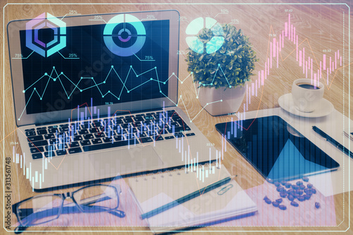 Double exposure of chart and financial info and work space with computer background. Concept of international online trading.