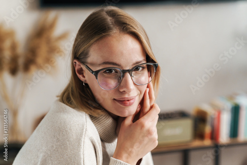Photo of nice pleased woman in eyeglasses looking at camera
