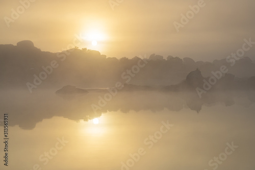 Sunrise with fog in the natural park of Los Barruecos. Extremadura. Spain.