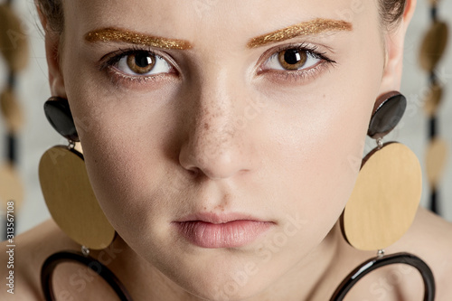 girl with fashion makeup posing in the Studio on a white background with garlands