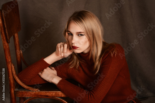 girl in a beautiful brown fur coat posing in the Studio on a brown background