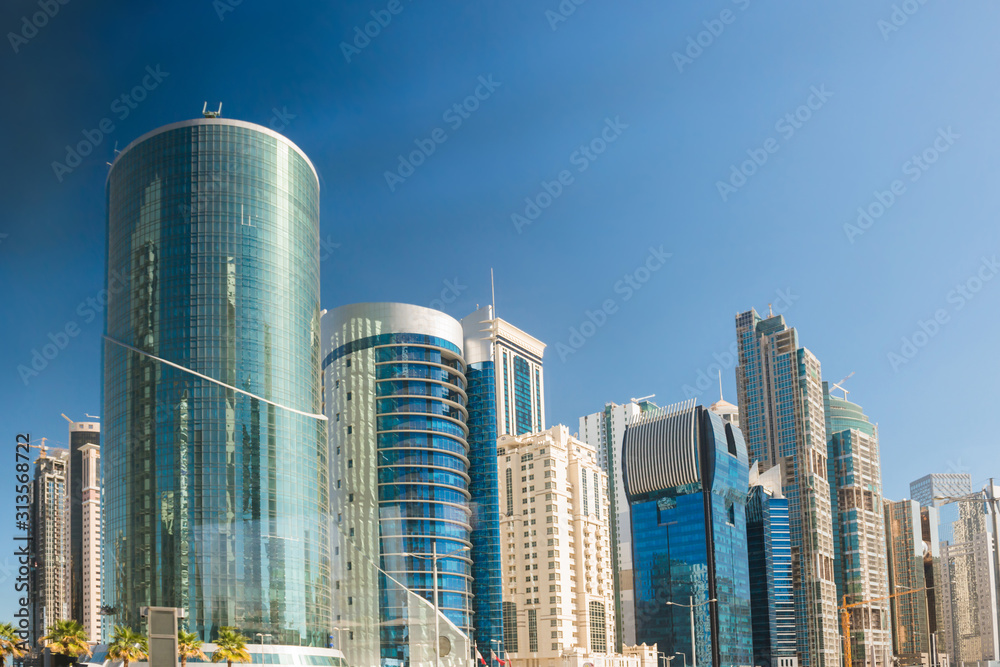 Skyscrapers and modern office buildings at downtown of Doha city on clear sky background. Doha