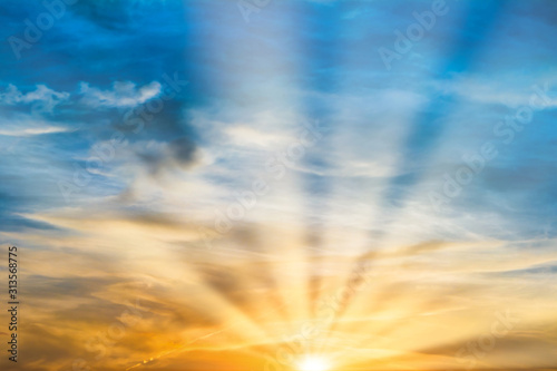Beautiful dramatic sunset with sun rays and clouds