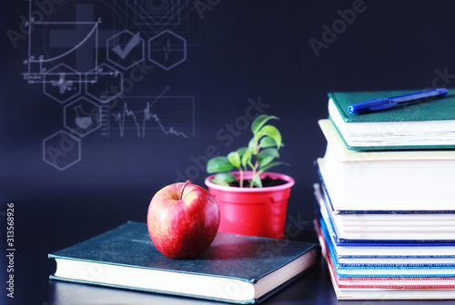 A stack of textbooks and books on the table. The concept of knowledge. photo