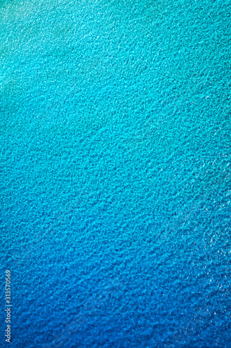 Sea surface aerial view. Background image of the turquoise sea. Deep sea and corals. Aerial drone shot of turquoise water, space for text. Aquamarine background. Sea Aerial view.