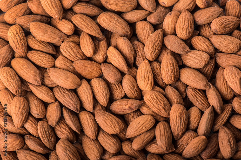 Almonds nut on white wooden table. Almond healthy raw food background. Almonds nut on white wooden table. Almond healthy raw food background.
