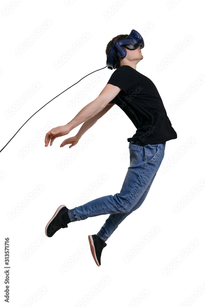 Excited young male in VR glasses flying through spase. Using VR headset, white background. Concept of the future is here Excited young male in VR glasses flying through spase. Using VR headset, white background. Concept of the future is here