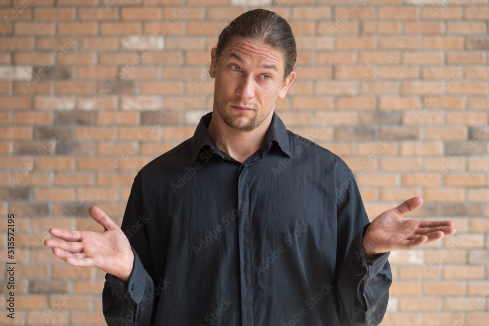 Man shrugging and thinking with question, problem, suspicion, uncertainty, doubt, doubtful mood Man shrugging and thinking with question, problem, suspicion, uncertainty, doubt, doubtful mood