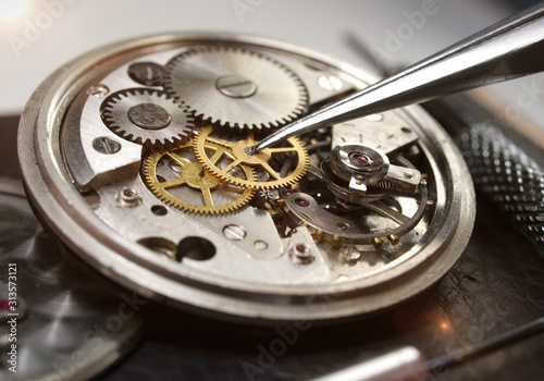 close up macro pic of watchmaker repairin vintage cronograph wath mechanism