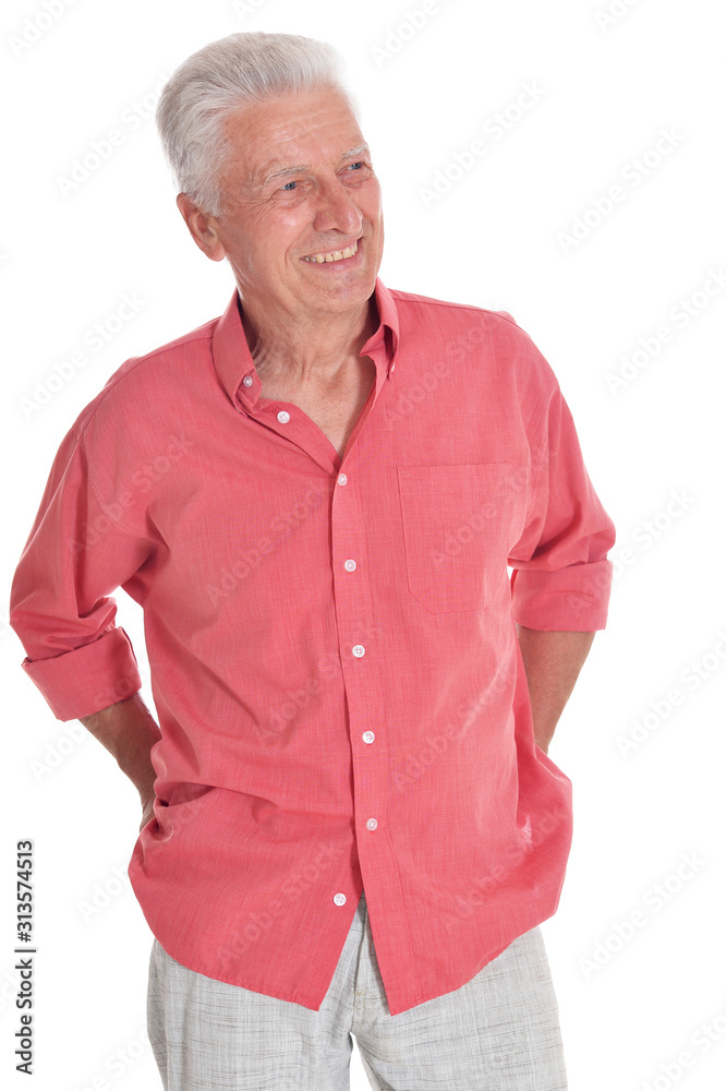 Smiling senior man holding hands in pockets posing Smiling senior man holding hands in pockets posing