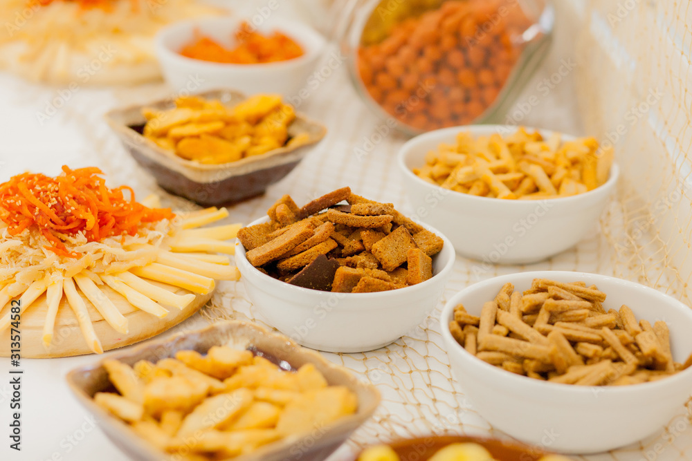 A lots of salty snacks on a table, many cheese and crackers on the table with snacks A lots of salty snacks on a table, many cheese and crackers on the table with snacks