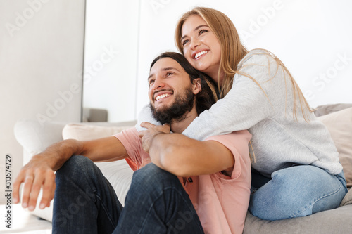 Loving couple on sofa watch tv film © Drobot Dean