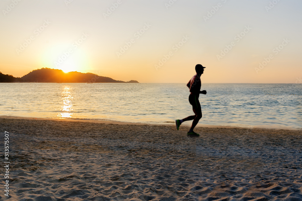 Silhouette of man running on the beach at sunset. Sport and healthy lifestyle