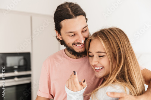 Happy young couple embracing while cooking