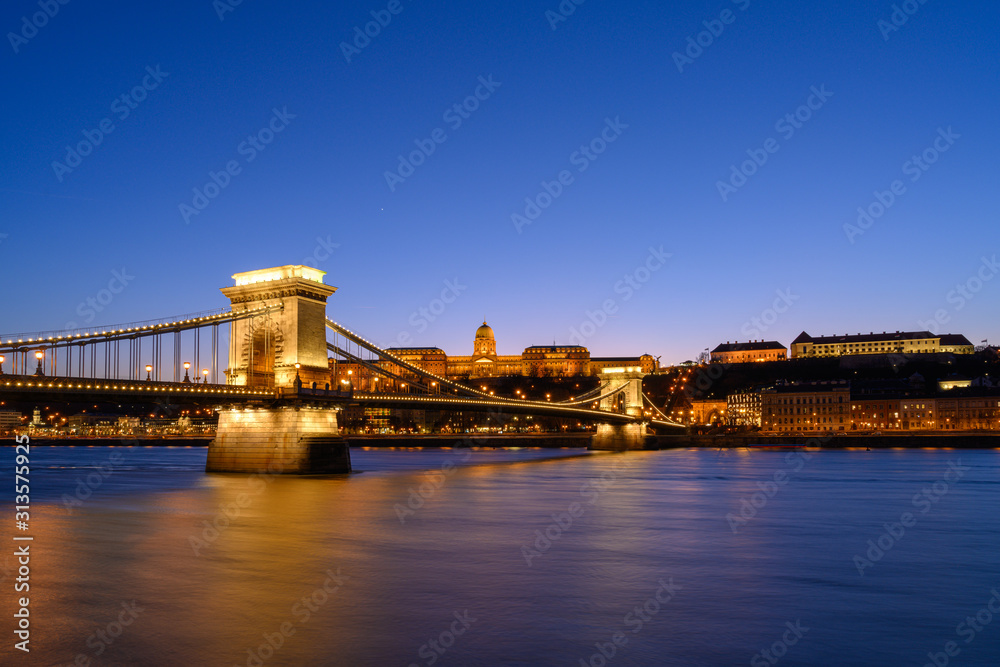 Budapest iconic Chain Bridge by night over the Danube River with the Royal Palace and the President's Palace Budapest iconic Chain Bridge by night over the Danube River with the Royal Palace and the President's Palace