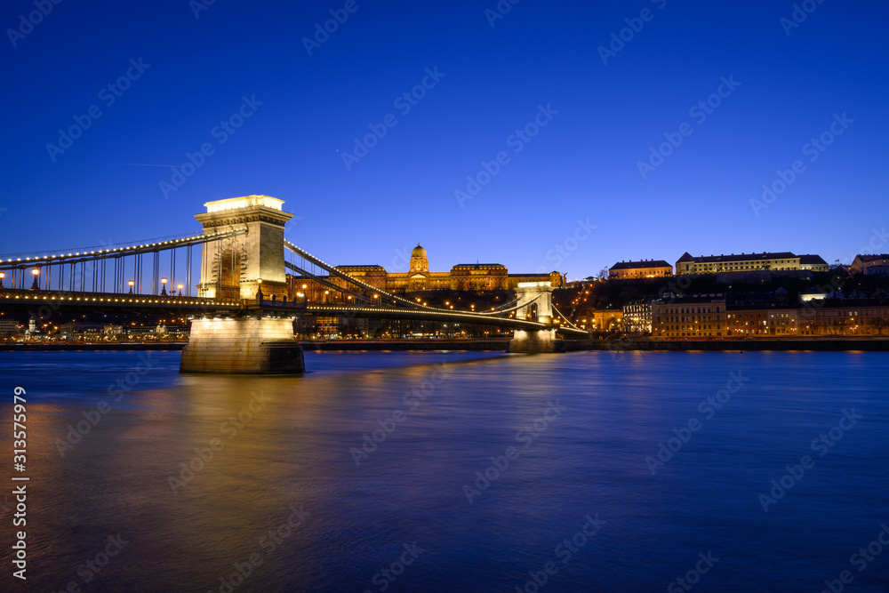 Budapest iconic Chain Bridge by night over the Danube River with the Royal Palace and the President's Palace Budapest iconic Chain Bridge by night over the Danube River with the Royal Palace and the President's Palace