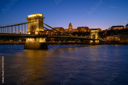 Budapest iconic Chain Bridge by night over the Danube River with the Royal Palace and the President's Palace