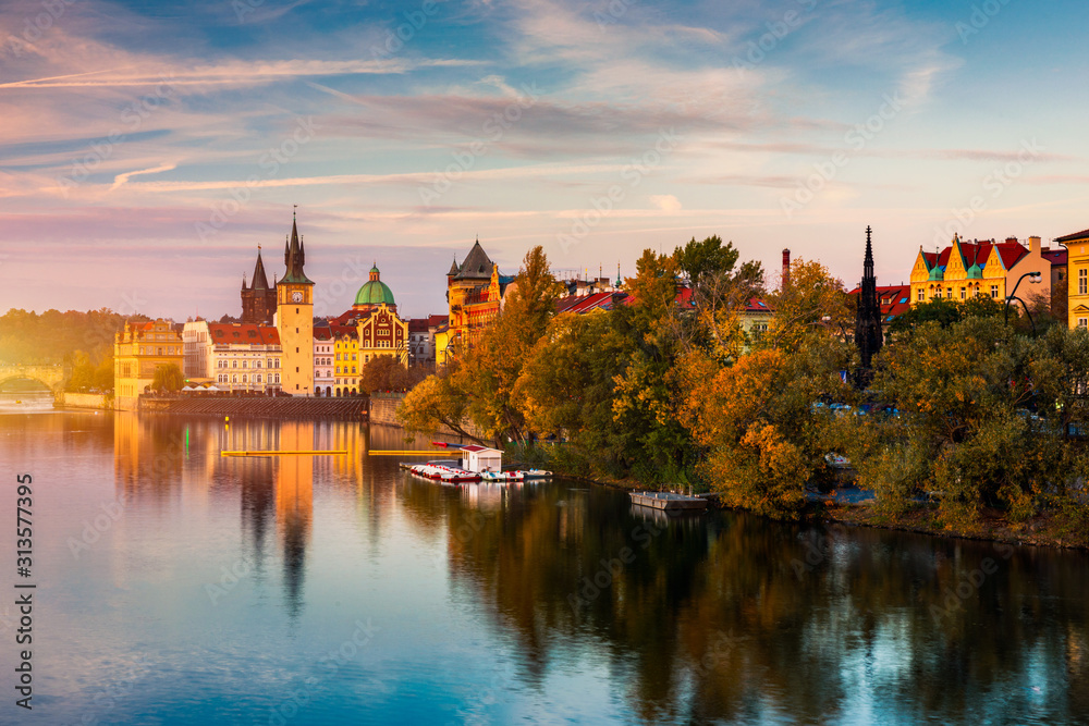 Autumn view to Charles bridge on Vltava river in Prague, Czech Republic. Autumn view to Charles Bridge, Prague old town and Vltava river. Czechia. Scenic autumn view of the Old Town with red foliage. Autumn view to Charles bridge on Vltava river in Prague, Czech Republic. Autumn view to Charles Bridge, Prague old town and Vltava river. Czechia. Scenic autumn view of the Old Town with red foliage.