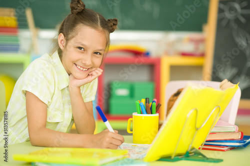 Close up portrait of girl doing homework