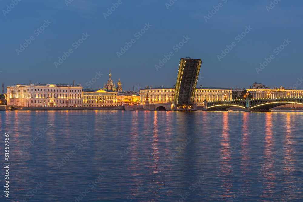 raised span of the Trinity bridge on the background of historical buildings on the embankments