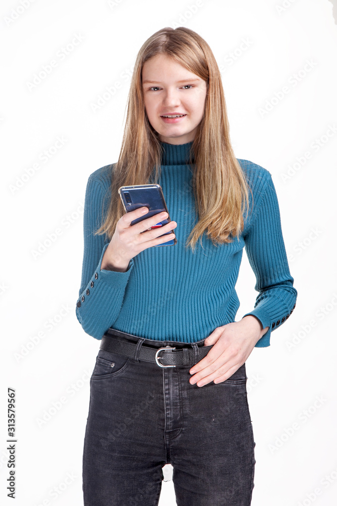 Fototapeta premium teen girl uses the phone on a white background