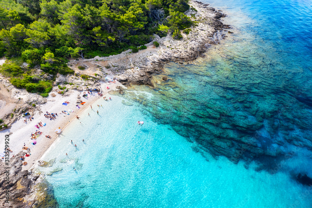 Aerial view on the beach, stones and azure sea. Beach and sea from air. Summer seascape from drone. Croatia landscape. Travel - image