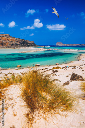 Fototapeta Naklejka Na Ścianę i Meble -  Balos Lagoon and Gramvousa island on Crete with seagulls flying over, Greece. Cap tigani in the center. Balos beach on Crete island, Greece. Crystal clear water of Balos beach.