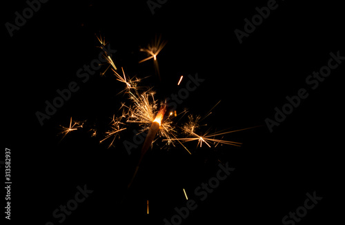 Sparklers burn in the dark  creating a festive mood.