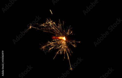 Sparklers burn in the dark  creating a festive mood.
