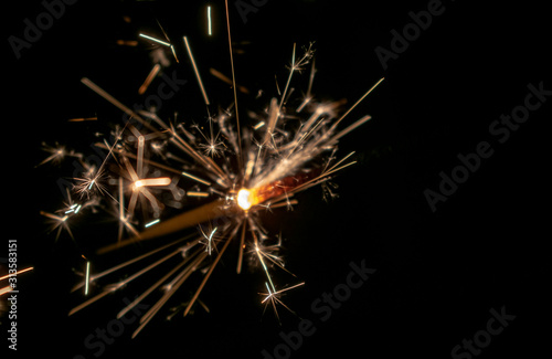 Sparklers burn in the dark  creating a festive mood.