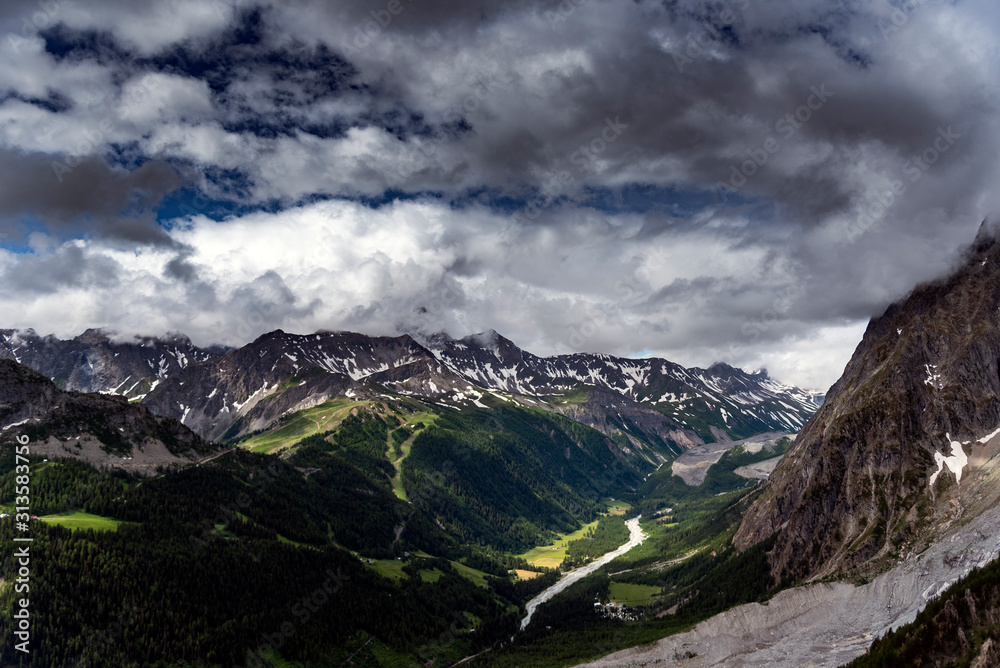 Alpine summits near Mont Blanc in clouds, Italy side.