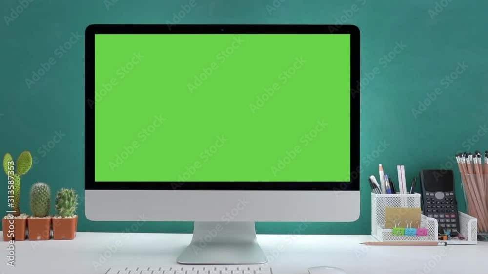 Computer desktop with mock-up green screen white background in office and Lovely cactus in brown pot , Zoom shoulder view. Computer desktop with mock-up green screen white background in office and Lovely cactus in brown pot , Zoom shoulder view.