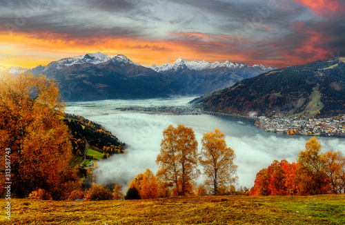 Impressively beautiful Fairy-tale mountain lake in Austrian Alps. Beautiful mountain landscape in the Alps with Zeller Lake in Zell am See, Salzburger Land, Austria. Fantastic Autumn Scene at sunset photo