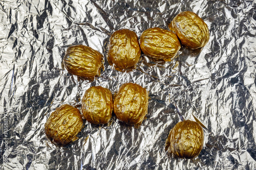 Golden walnuts on a silver background