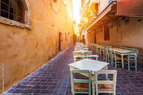 Fototapeta Naklejka Na Ścianę i Meble -  Street in the old town of Chania, Crete, Greece. Charming streets of Greek islands, Crete. Beautiful street in Chania, Crete island, Greece. Summer landscape. Chania old street of Crete island Greece.
