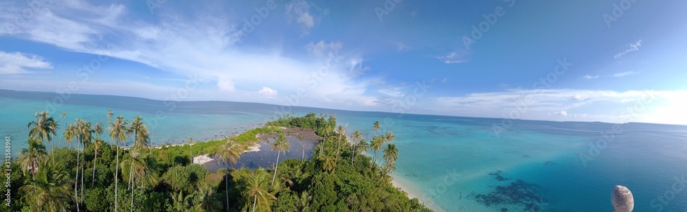 tropical island in the sea Panoramic View Of Beach Against Cloudy Sky - stock photo