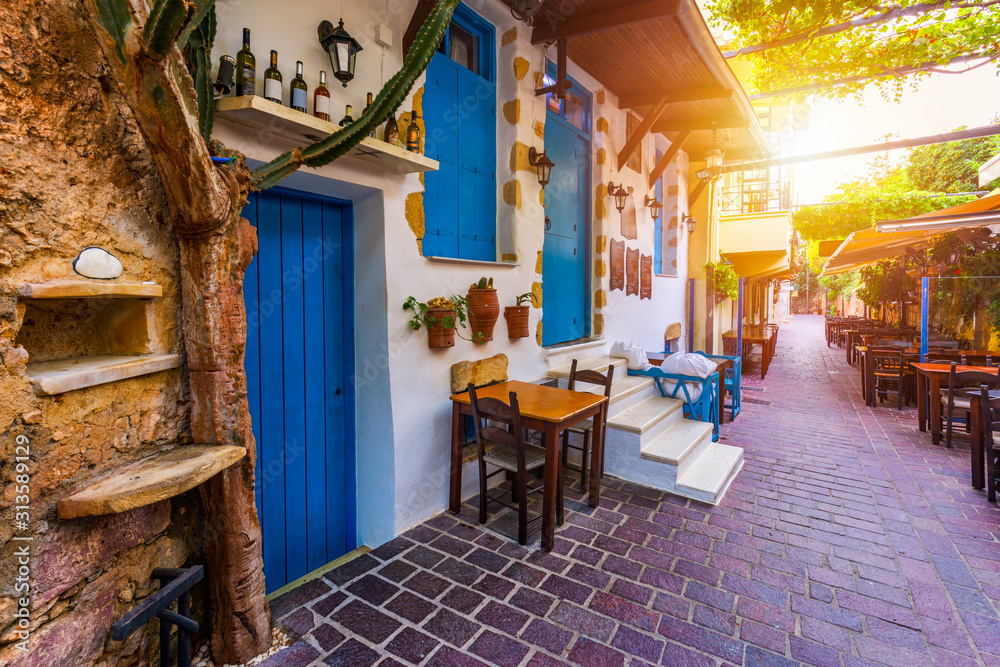 Obraz premium Street in the old town of Chania, Crete, Greece. Charming streets of Greek islands, Crete. Beautiful street in Chania, Crete island, Greece. Summer landscape. Chania old street of Crete island Greece.