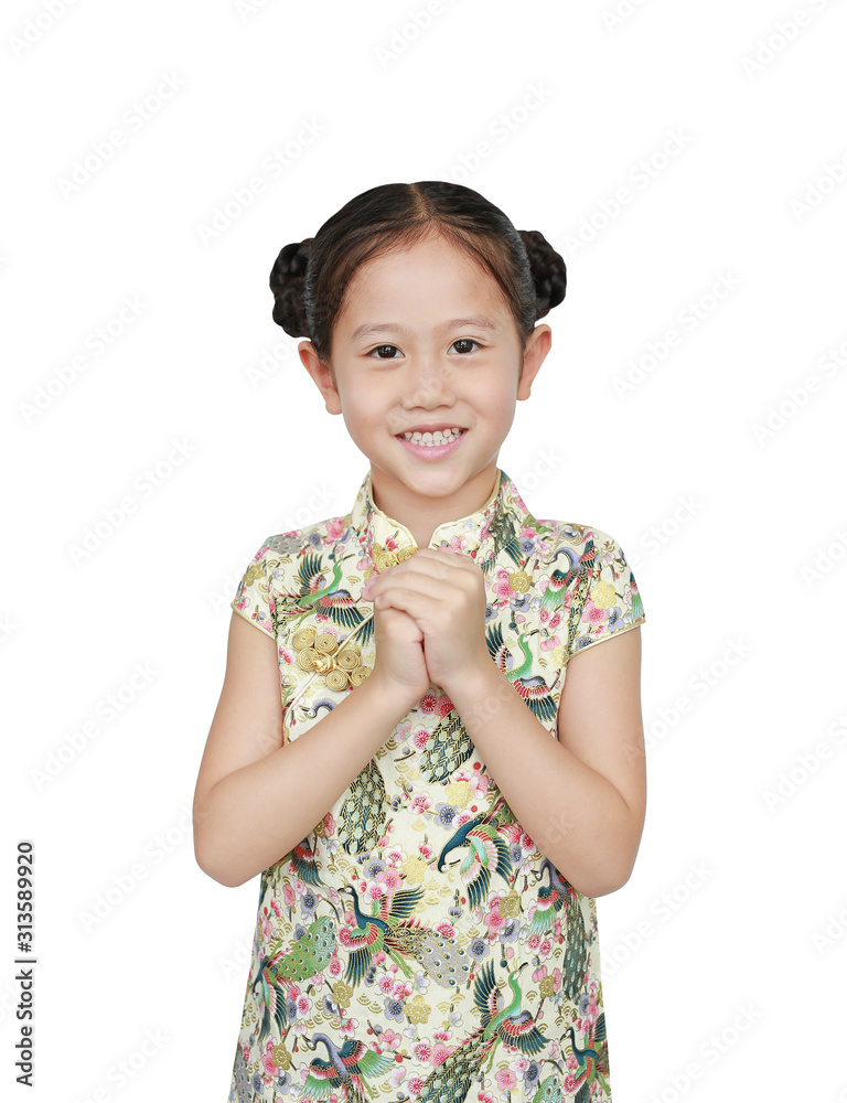 Asian little girl in chinese traditional dress with greeting gesture celebrating for happy Chinese New Year. Asian little girl in chinese traditional dress with greeting gesture celebrating for happy Chinese New Year.