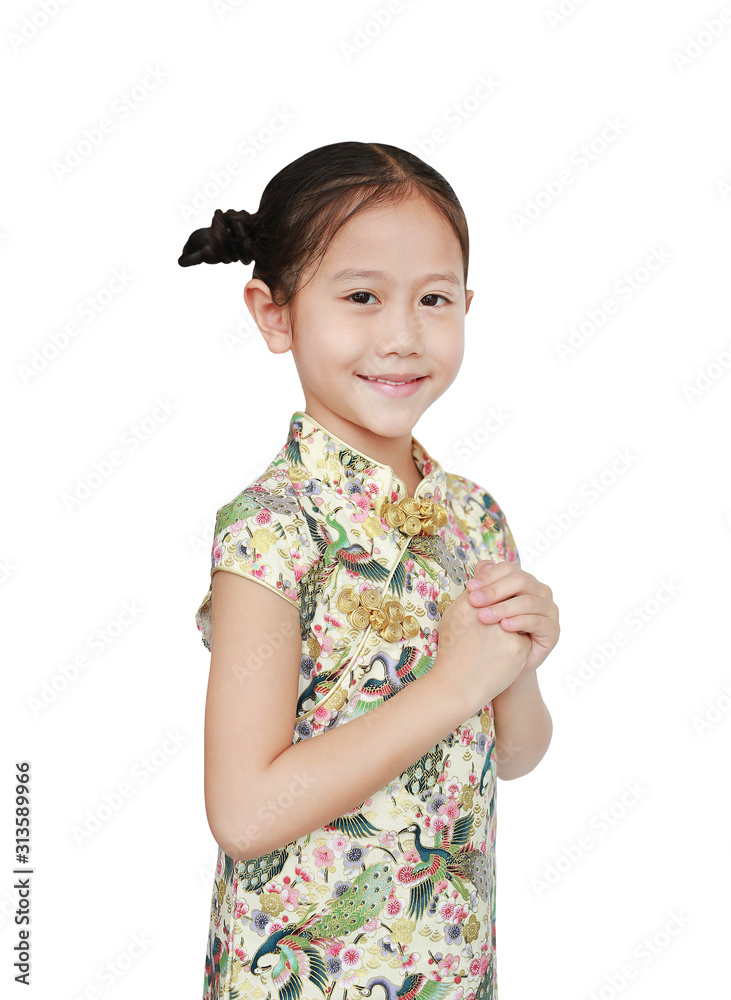 Beautiful Asian little girl in traditional cheongsam with greeting gesture celebration for happy Chinese New Year over white background Beautiful Asian little girl in traditional cheongsam with greeting gesture celebration for happy Chinese New Year over white background