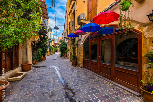 Fototapeta Naklejka Na Ścianę i Meble -  Street in the old town of Chania, Crete, Greece. Charming streets of Greek islands, Crete. Beautiful street in Chania, Crete island, Greece. Summer landscape. Chania old street of Crete island Greece.